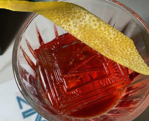 Tomato Negroni | IMAGE Available at: The Eighty Six Ingredients: • 1.5 oz Second Sip Gin • .75 oz Tomato Campari • .75 oz Basil Dolin Blanc • .75 oz Tomato Water Glass: Rocks Ice: Large cube Garnish: Maldon salt and basil leaf Method: Add all ingredients to the glass and stir for 10 revolutions. Serve over a large ice cube and garnish with Maldon salt and a basil leaf. +++ Chocolate Negroni | IMAGE Available at: Romeo’s (East Village, NYC) Ingredients: • 3 dashes Scrappy's Chocolate Bitters • 3 oz Chocolate Negroni Batch • 1 oz Neversink Gin • 1 oz Campari • 0.75 oz Cocchi Rosa • 0.25 oz Tempus Fugit Crème de Cacao Glass: Rocks Method: Stir and strain over large rock Garnish: Terry's Chocolate Orange segment +++ Miami Vice Negroni | IMAGE Available at: Sip & Guzzle Created by: Steve Schneider Ingredients: • 250ml Fords Gin • 250ml Campari • 250ml Martini Rosso • 250g strawberries • 150ml coconut oil Method: Stem and quarter strawberries. Combine all ingredients except coconut oil in a vacuum bag and sous vide at 52° C for two hours. Strain through Superbag. Melt coconut oil and combine with infused batch. Let sit at room temperature for two hours. Store in freezer overnight. Strain through two coffee filters. Makes a 3 oz batch that is stirred then strained over a large ice cube. Beetnik | IMAGE Available at: KEES Ingredients: • Añejo Tequila • Sweet Vermouth • Campari • Beet • Cinnamon *specs available upon request TMNT Negroni | IMAGE Bartender Credit: David Muhs Available at Sama ‘Za Image credit: Alex Staniloff Ingredients: • 3/4 oz Tomato Water • 1/4 oz Lustau Dry Vermut • 1/4 oz Orleans Herbal Aperitif Cider • 1/2 oz Noilley Prat Extra Dry Vermouth • 3/4 oz Luxardo Bitter Bianco • 1 oz Parmesan Rind Condesa Clasìca Gin Glass: Rocks Method: small stir to chill Garnish: finish with some drops of basil oil